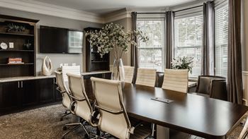 A conference room with a long table and chairs